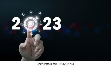 Finger pressing blue start 2023 button on virtual interface on gray background with copy space for text. Concept of new year. Businessman pressing 2023 start up business. Beginning of New Year 2023 - Shutterstock ID 2189171753