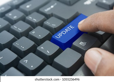 finger pressing blue update button