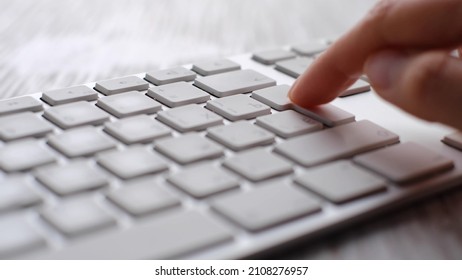 Finger pressing an enter key. Computer user hitting the enter key, up close. Confirmation, sending a message - Shutterstock ID 2108276957