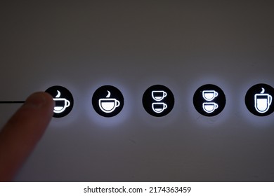 Finger pressing espresso button in automatic coffee machine. High quality photo
