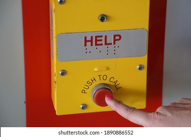 Finger pressing help button for assistance   