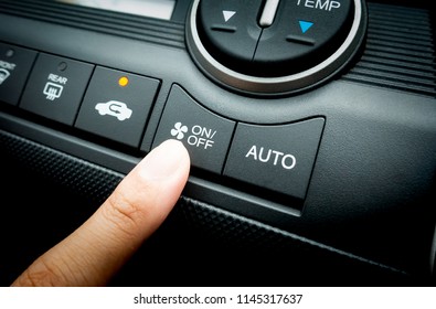 Finger Pressing On Power Button On Off Switch Of A Car Air Conditioning And Heating System To Turn On The Fan Of The A/C Inside The Car