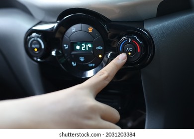 Finger Pressing On Power Button On Off Switch Of A Car Air Conditioning And Heating System To Turn On The Fan Of The AC Inside The Car. Auto Climate Control