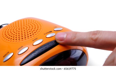 Finger Pressing A Snooze Alarm Button