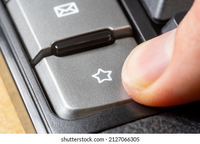 Finger pressing a star symbol icon button, man clicking the favorite bookmark key, liking, adding to favorites, bookmarking a webpage, website seo rating abstract concept, object extreme closeup