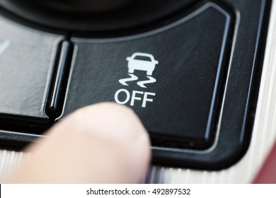 Finger Pressing Traction Control System Button 