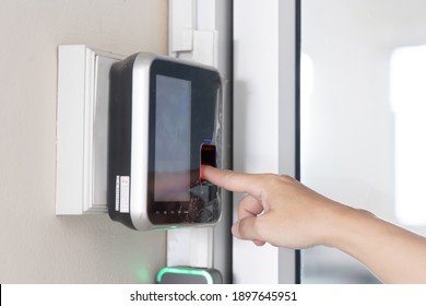 Finger print scan, Male employees press sensors to record company attendance time and after work, Time Recorder Attendance - Out work, Encryption for identity verification or electronic signing
