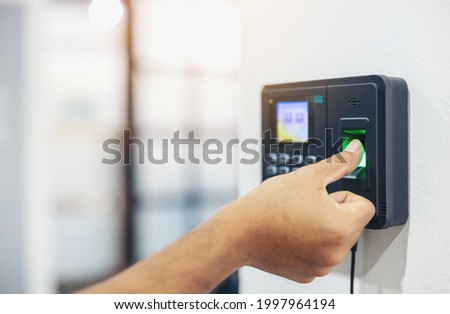 Finger print scan, Male employees press sensors to record company attendance time and after work, Time Recorder Attendance - Out work, Encryption for identity verification or electronic signing