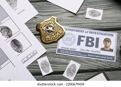 Finger prints with document of FBI agent and badge on wooden background - Shutterstock ID 2200679459