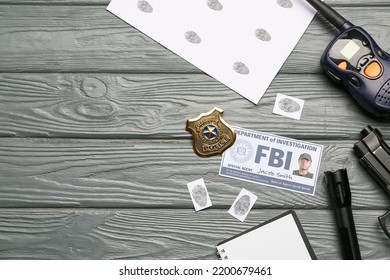 Finger Prints With Document Of FBI Agent And Accessories On Wooden Background