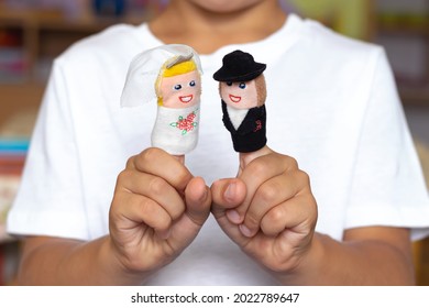 Finger Puppet Theater. Children's Hand With Figures Of Dolls. Bride And Groom. Wedding. Family Concept.