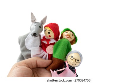 Finger puppet of wolf, red riding hood, archer and grandma. Concept of kids European fairy tale Little Red Riding Hood. Isolated on white background. Copy space.