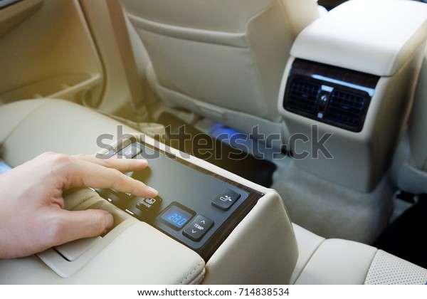 a finger push button to control electronic\
devices in back seat of  luxury\
car.
