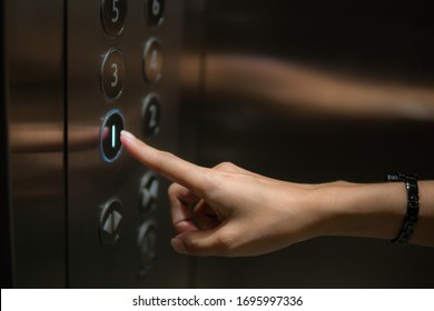 The finger is the push button of the elevator.