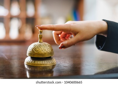 Finger Push On The Hotel Reception Bell. Close Up