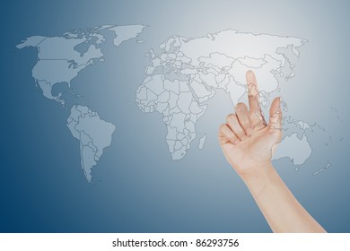 finger pushing the button world map screen