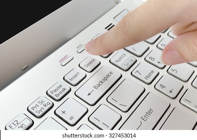 Finger Pushing Delete Button On Laptop Keyboard