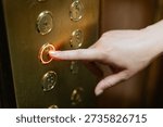 Finger pushing old elevator button