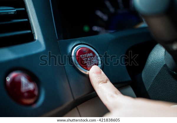 Finger pushing start button engine car , engine\
start stop