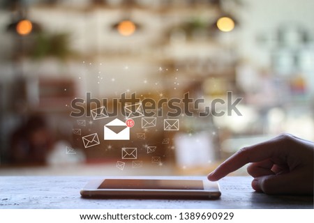 finger touch mobile check e-mail on coffee shop background with copy space. Communication concept. Double exposure