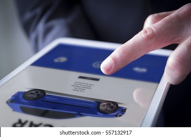 Finger Touches Digital Tablet Showing Car Website On Screen