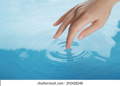 Finger Touches Water Close Up