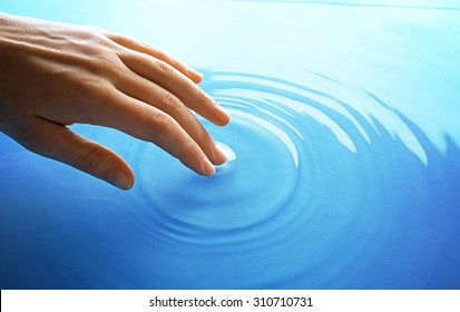 Finger Touches Water Close Up