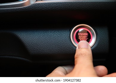 Finger Touching Car Engine Start Button On Car Icon Of Car Background. New Technology Of Car. Transportation And Sefety Concept.