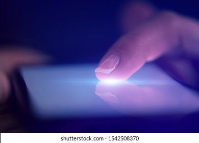 Finger Touching Phone With Dark Background With Copyspace