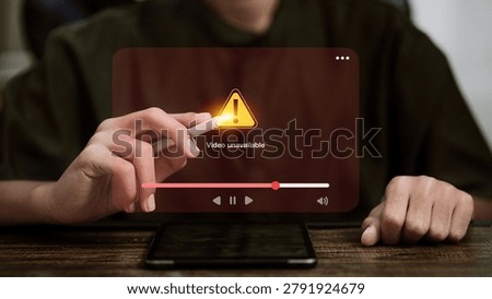 Finger touching warning triangle on video unavailable error screen with red progress bar and playback controls on smartphone, representing streaming error, content blocked, and video playback issue concept.