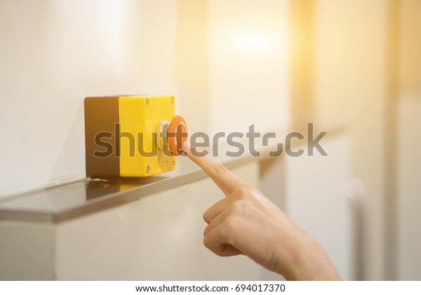 Finger of women pressing emergency sos button to\
contact with call center to ask for help after car accident ,hand\
trying to press in front of the elevator,safety first and security\
background concept
