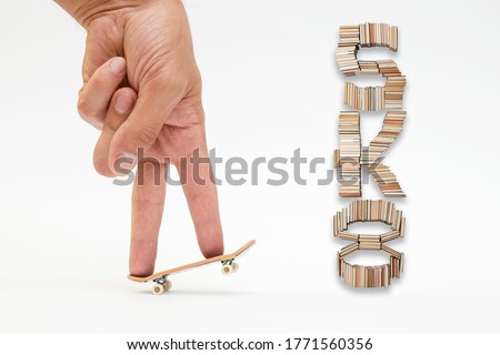 Fingerboard and sk8 text on white background. A small skateboard for kids and teenagers to play with hand fingers