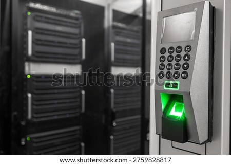 Fingerprint access control system in a data center with server racks in the background