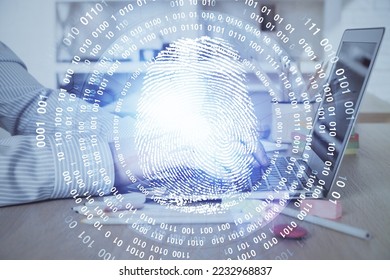 Fingerprint hologram with businessman working on computer on background. Security concept. Double exposure. - Shutterstock ID 2232968837