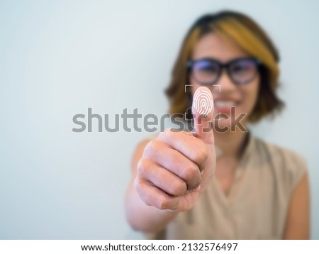 Fingerprint icon with woman thumb wearing glasses scanning for security access with biometrics identification on white background with copy space. Business technology safety internet network concept.