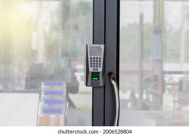 Fingerprint Scanner On Glass Door For Unlock Door Security System. The Fingerprint Scanner Control Machine For Record Work Time, Unlock Door Office.