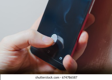 Fingerprint scanner on the phone screen. Touch screen smartphone with a zone to touch the human finger, to unlock the device.