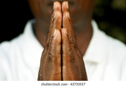 fingers of afro man in prayer