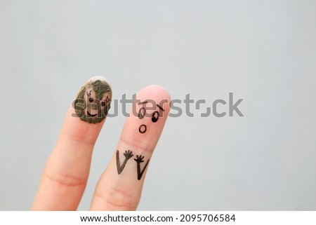 Fingers art of couple. Husband saw his wife with clay face mask and was afraid.
