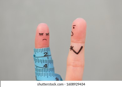 Fingers art of couple with meter. Concept husband is angry that his wife can not lose weight.