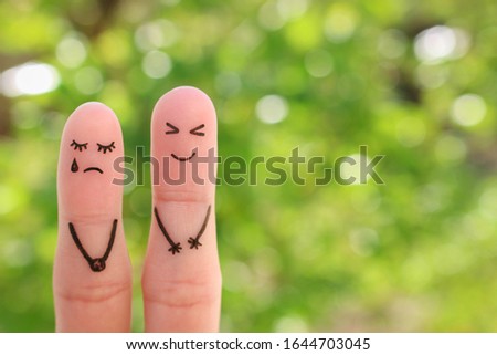 Fingers art of couple. Woman cries, man laughs.