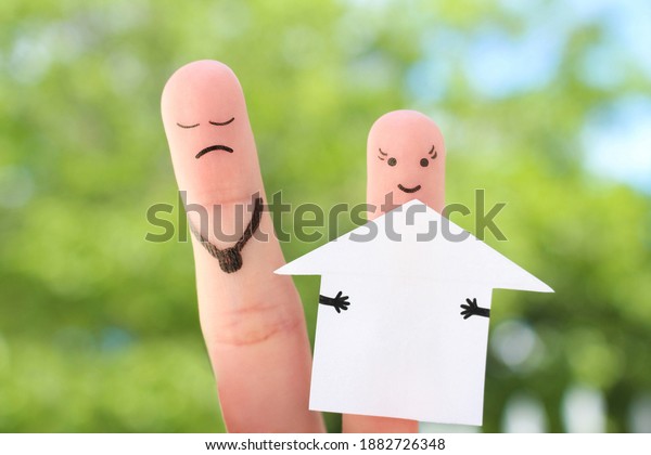 Fingers art of family during quarrel.
Concept of man and woman divide house after
divorce.