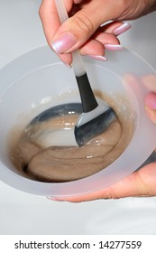 Fingers Of A Beautician Holding Brush And Making A Color Mix For Coloring Hair