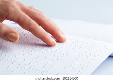 fingers and braille. blind people read a book in braille.
