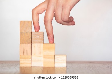 Fingers climbing stairs to the top. Concept of success and achievement