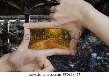 fingers creating a square making the vision of garbage and ruins turn to clean nature