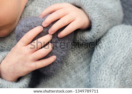 fingers of a newborn baby, heart in the hands of mom and dad, hands and nails of a child, the first days of life after birth, 