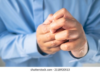 Fingers pain in office syndrome concept. Salaryman wears a blue shirt. Medium close up shot. - Shutterstock ID 2118920513