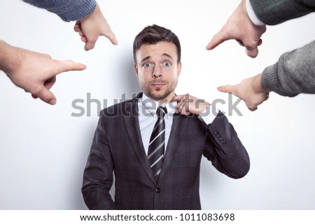 Fingers pointing at a businessman 