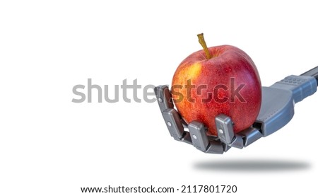 fingers squeeze a fresh apple in the robots hand. future technologies and ecology. robotics applicable in agriculture and natural products trade. artificial intelligence and nature.